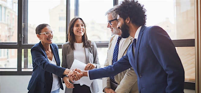 Smooth closing realtors and clients shaking hands