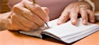 Woman signing an earnest money check